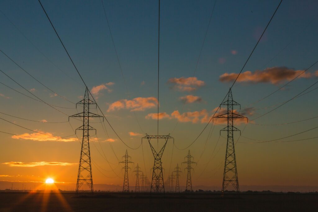 Electricity pylons at sunset carrying power to UK businesses