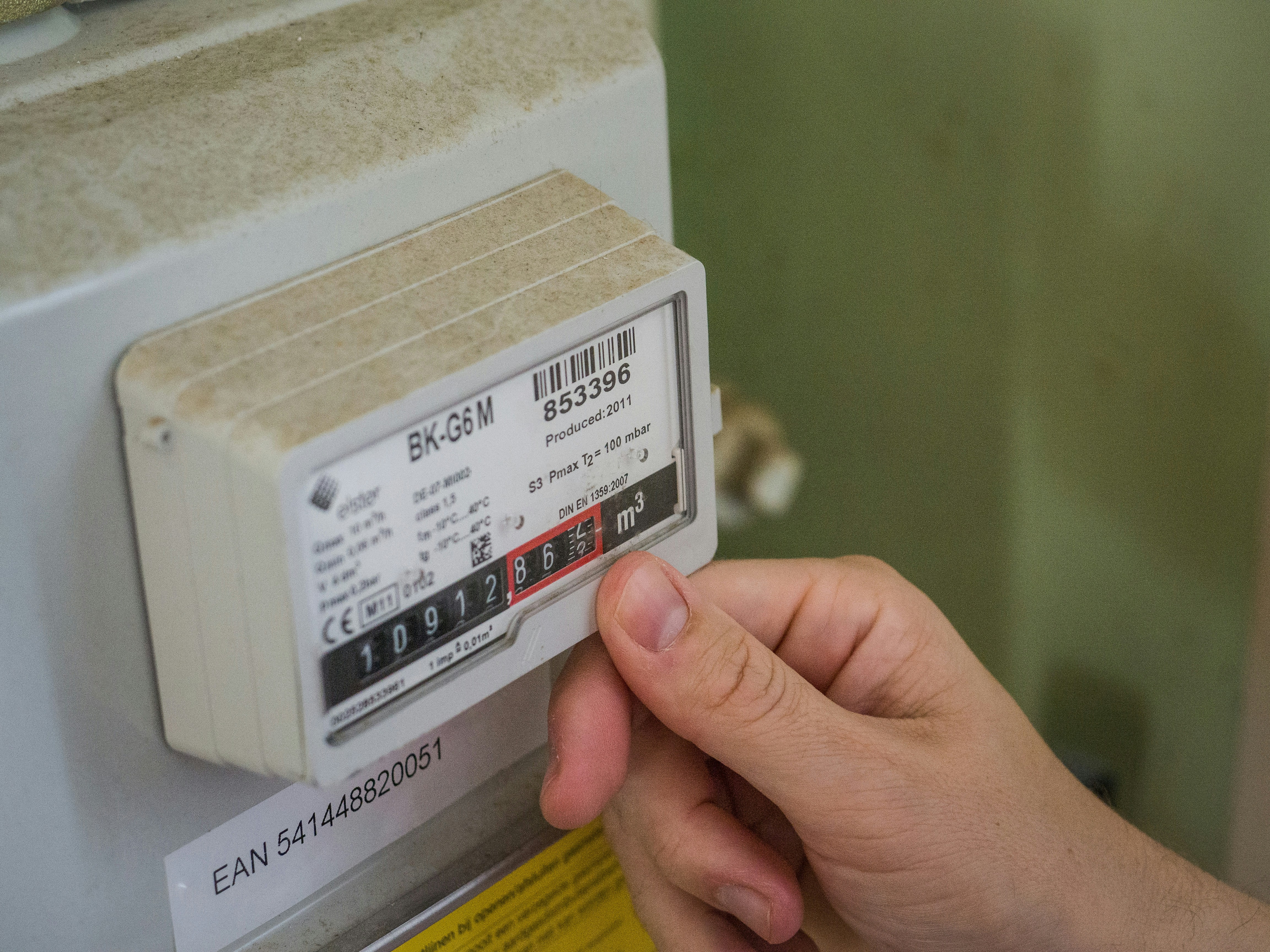Commercial gas meter and regulator installed in a meter housing