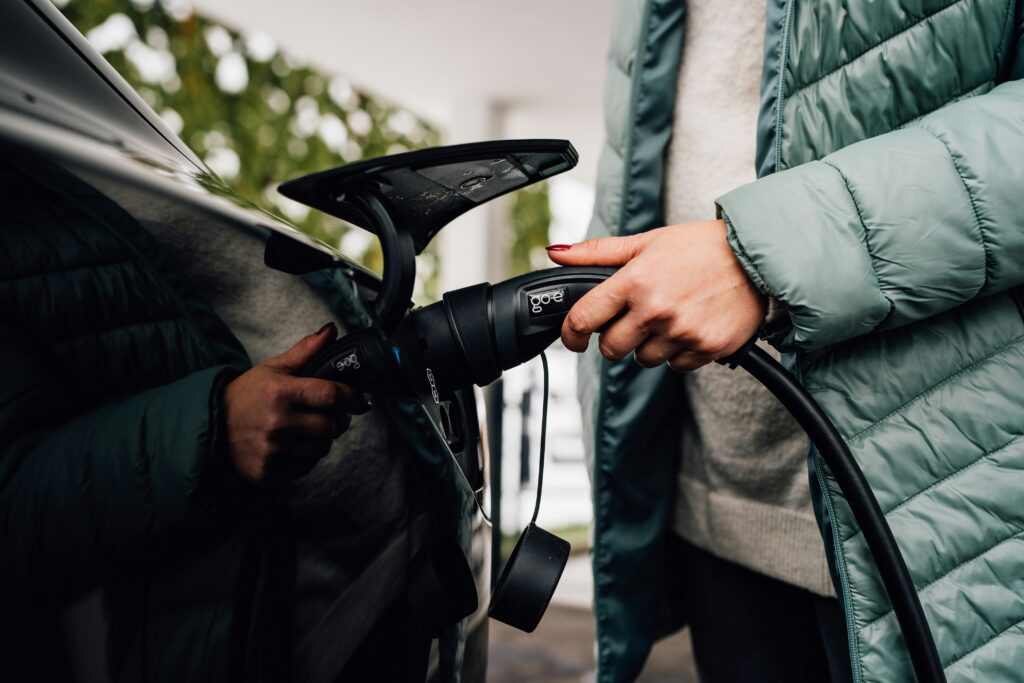 eforenergy.co.uk | Workplace EV Charging: Grants, Costs and Setup Explained Man pluggin gin EV charger for car