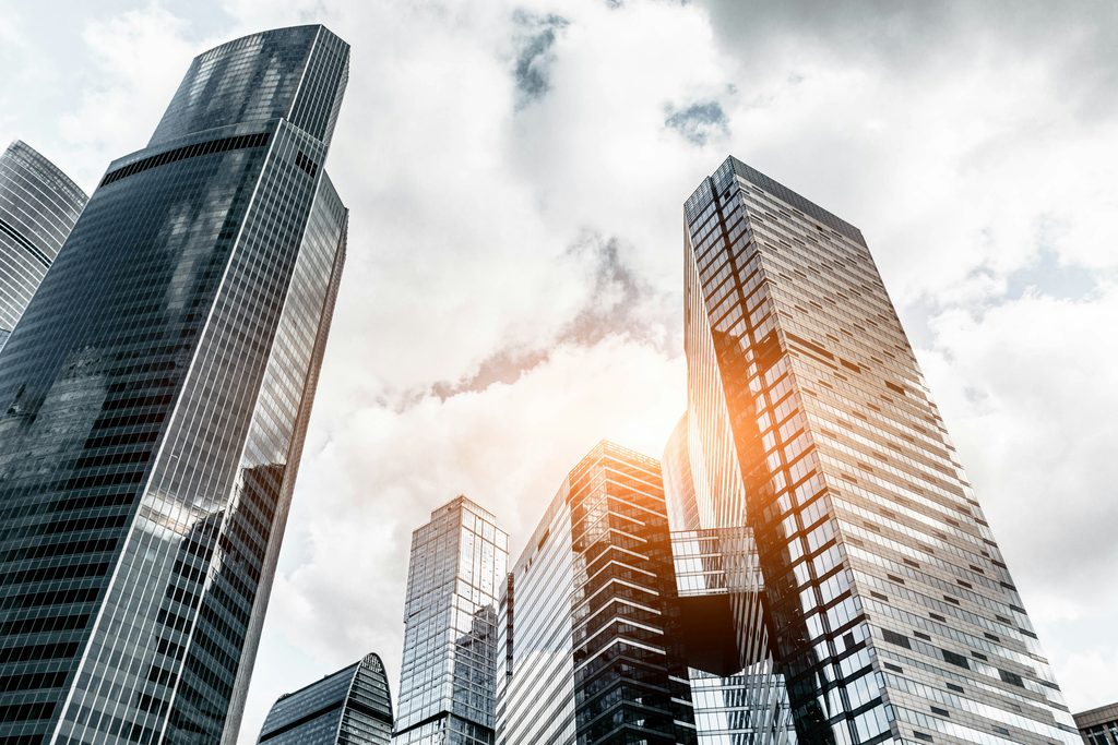 christian wiediger RYWEyXopmM4 unsplash - tall glass buildings with sun reflecting off the glass