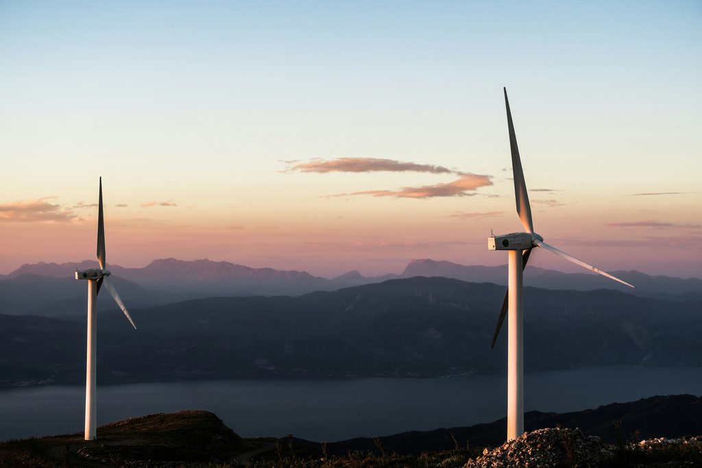 jason mavrommatis s1w1SguZTI unsplash - Image of wind turbines creating energy with mountains in the background
